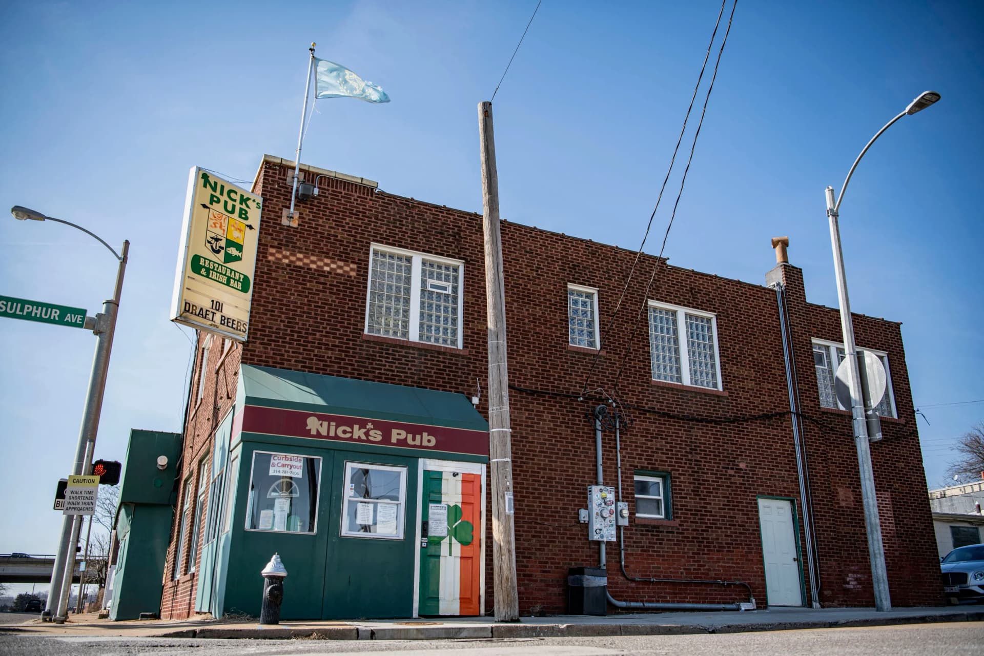 The Nick's Pub corner storefront with its shamrock door